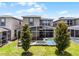 This beautiful home features a screened-in pool, lush green lawn, and mature trees for shade and privacy at 661 Drop Shot Dr, Davenport, FL 33896