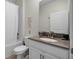 Cozy bathroom features a shower/tub combo and vanity area with a single sink at 661 Drop Shot Dr, Davenport, FL 33896