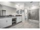 Bright bathroom with a double vanity, framed art, and glass enclosed shower at 661 Drop Shot Dr, Davenport, FL 33896