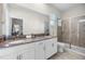 Beautiful bathroom with double vanity sinks, a walk-in shower, and modern fixtures and finishes at 661 Drop Shot Dr, Davenport, FL 33896