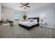 Bright bedroom with a queen bed, a view from the window, and a ceiling fan at 661 Drop Shot Dr, Davenport, FL 33896