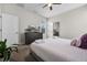 Well-lit bedroom features a dresser, TV, queen bed, and decor at 661 Drop Shot Dr, Davenport, FL 33896