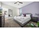 Bedroom with a queen bed, nightstands, a dresser, and an attached bathroom at 661 Drop Shot Dr, Davenport, FL 33896