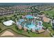 Expansive community pool area featuring multiple pools, lounge chairs, and tropical landscaping at 661 Drop Shot Dr, Davenport, FL 33896