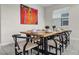 The dining area features stylish decor, including a modern table setting and a vibrant art piece at 661 Drop Shot Dr, Davenport, FL 33896