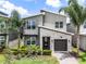 A charming two-story house with a modern design, beautiful stonework, and lovely landscaping at 661 Drop Shot Dr, Davenport, FL 33896
