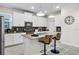 A modern kitchen featuring white cabinets, stainless steel appliances, and a gray tiled backsplash at 661 Drop Shot Dr, Davenport, FL 33896