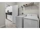 Convenient laundry area with washer, dryer, and storage space, located near the kitchen at 661 Drop Shot Dr, Davenport, FL 33896