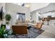 A bright living room with high ceilings, a modern rug, and a view of the adjacent kitchen area at 661 Drop Shot Dr, Davenport, FL 33896