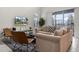 A well-lit living room has comfortable seating, a modern rug, and a view of the screened-in patio at 661 Drop Shot Dr, Davenport, FL 33896