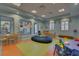 Community playroom with colorful seating, tables, toys, and large windows at 661 Drop Shot Dr, Davenport, FL 33896