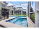 Relax in this screened-in pool and spa area with beautiful tile work and plenty of space for entertaining guests at 661 Drop Shot Dr, Davenport, FL 33896
