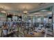 Community restaurant with bar, dining tables, chairs, and modern lighting at 661 Drop Shot Dr, Davenport, FL 33896