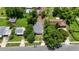 Aerial view of a home with gray roof surrounded by mature trees, showing neighborhood context on a sunny day at 722 Carlson Dr, Orlando, FL 32804