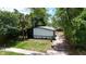 Backyard view of home, showing the newly renovated home, landscaping, and mature trees at 722 Carlson Dr, Orlando, FL 32804