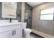 Modern bathroom featuring a marble shower, stone flooring, and black fixtures at 722 Carlson Dr, Orlando, FL 32804