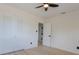 Bedroom features white walls, light wood flooring, ceiling fan, and a closet with bi-fold doors at 722 Carlson Dr, Orlando, FL 32804