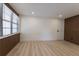 Well-lit bedroom featuring natural lighting, wooden accent wall, and minimalist design at 722 Carlson Dr, Orlando, FL 32804