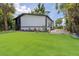 Charming home with a large lawn, lush landscaping, and a contemporary black and white design at 722 Carlson Dr, Orlando, FL 32804