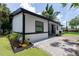 Charming single-story home boasting black trim, a well-maintained lawn, and a brick paver driveway at 722 Carlson Dr, Orlando, FL 32804