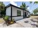 Charming single-story home with black trim, manicured landscaping, and a brick paver walkway at 722 Carlson Dr, Orlando, FL 32804
