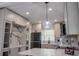 Beautiful kitchen with stainless steel appliances, a marble backsplash, and modern pendant lighting at 722 Carlson Dr, Orlando, FL 32804