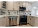 Modern kitchen with stainless steel appliances, oven and dishwasher and marble backsplash at 722 Carlson Dr, Orlando, FL 32804