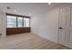 Bright living room featuring recessed lighting, wood flooring, and large windows with modern blinds at 722 Carlson Dr, Orlando, FL 32804