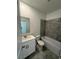 Bathroom featuring a single vanity, new toilet and a tub with tiled shower at 7717 Stone Creek Trl, Kissimmee, FL 34747