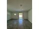 Bright, airy living room with large sliding glass doors and gray tile floors at 7717 Stone Creek Trl, Kissimmee, FL 34747