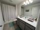 Well-lit bathroom with a shower/tub combo and vanity with gray cabinets at 775 Longboat Dr, Davenport, FL 33896