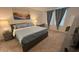 Cozy bedroom with a queen-sized bed, soft blue bedding, and serene wall art at 775 Longboat Dr, Davenport, FL 33896
