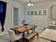 Bright dining room with a wooden table, cushioned chairs, and modern decorations at 775 Longboat Dr, Davenport, FL 33896
