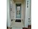 Inviting front entryway with a teal door and welcome mat at 775 Longboat Dr, Davenport, FL 33896