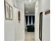 Inviting hallway featuring neutral walls, tasteful decor, and a glimpse into the living space at 775 Longboat Dr, Davenport, FL 33896