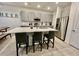Modern kitchen with gray cabinets, stainless steel appliances, and a quartz countertop island at 775 Longboat Dr, Davenport, FL 33896