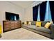Comfortable living room featuring a gray sofa, wood dresser, and bright decor at 775 Longboat Dr, Davenport, FL 33896