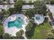 Aerial view of the community pool and hot tub area, showcasing a lush, tropical oasis at 7900 S Orange Blossom Trl # 2074, Orlando, FL 32809