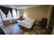 Bedroom featuring a comfortable bed, window, and simple furnishings at 7900 S Orange Blossom Trl # 2074, Orlando, FL 32809