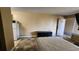 Functional bedroom featuring tile flooring, a comfortable bed, kitchenette, and ample space at 7900 S Orange Blossom Trl # 2074, Orlando, FL 32809