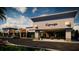 Commercial building featuring covered customer access, parking, and manicured landscaping at 7900 S Orange Blossom Trl # 2074, Orlando, FL 32809
