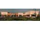 A commercial building featuring modern architecture, lush landscaping, and parking at 7900 S Orange Blossom Trl # 2074, Orlando, FL 32809