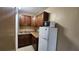 Efficient kitchenette with wood cabinets, sink, countertop, and refrigerator with microwave at 7900 S Orange Blossom Trl # 2074, Orlando, FL 32809