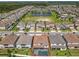 Gorgeous aerial view showcasing the home's pool and proximity to a community pond at 9071 Woodland Forest Rd, Orlando, FL 32836