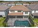 Aerial view of a home's backyard with a screened in pool and patio at 9071 Woodland Forest Rd, Orlando, FL 32836