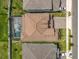 Aerial view of house with screened pool, featuring a tile roof and well-maintained yard at 9071 Woodland Forest Rd, Orlando, FL 32836