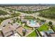Aerial view of community featuring swimming pool, playground, surrounding homes, and lush greenery at 9071 Woodland Forest Rd, Orlando, FL 32836
