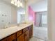 Bathroom showcasing a vanity with wood cabinets and a view into the bedroom at 9071 Woodland Forest Rd, Orlando, FL 32836