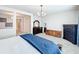 Bright bedroom with white walls, dark furniture and large mirror at 9071 Woodland Forest Rd, Orlando, FL 32836