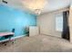 Carpeted bedroom featuring a blue accent wall, charming chandelier and natural light at 9071 Woodland Forest Rd, Orlando, FL 32836